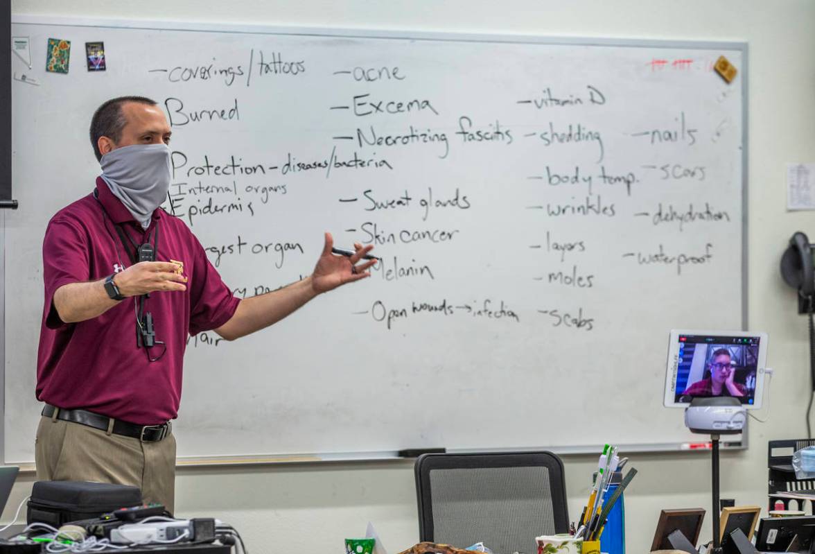 Teacher Steve Morrill stays socially distanced while teaching an anatomy and physiology class a ...