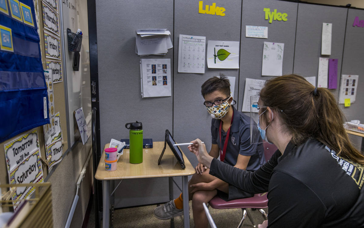 Student Luke Kreuger, left, works with instructor Amanda Abbott on a recycling assignment at th ...