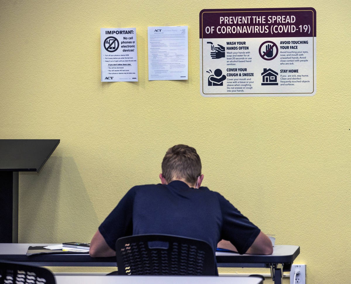More COVID-19 signage marks the walls within the library at Faith Lutheran Middle and High Scho ...