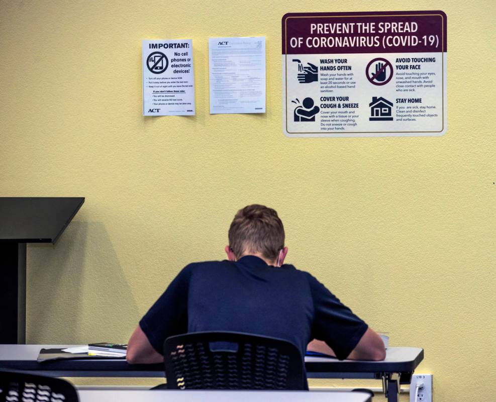 More COVID-19 signage marks the walls within the library at Faith Lutheran Middle and High Scho ...
