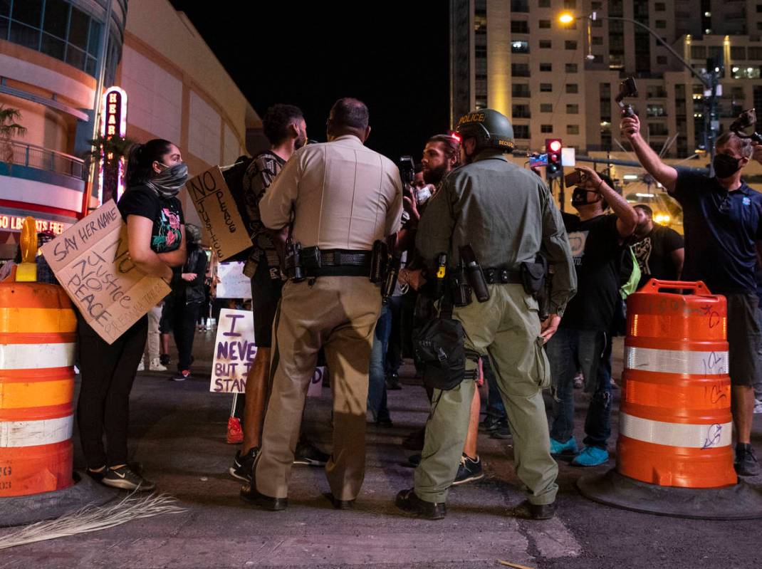 Protesters, calling for justice in the shooting death of Breonna Taylor, negotiate with law enf ...