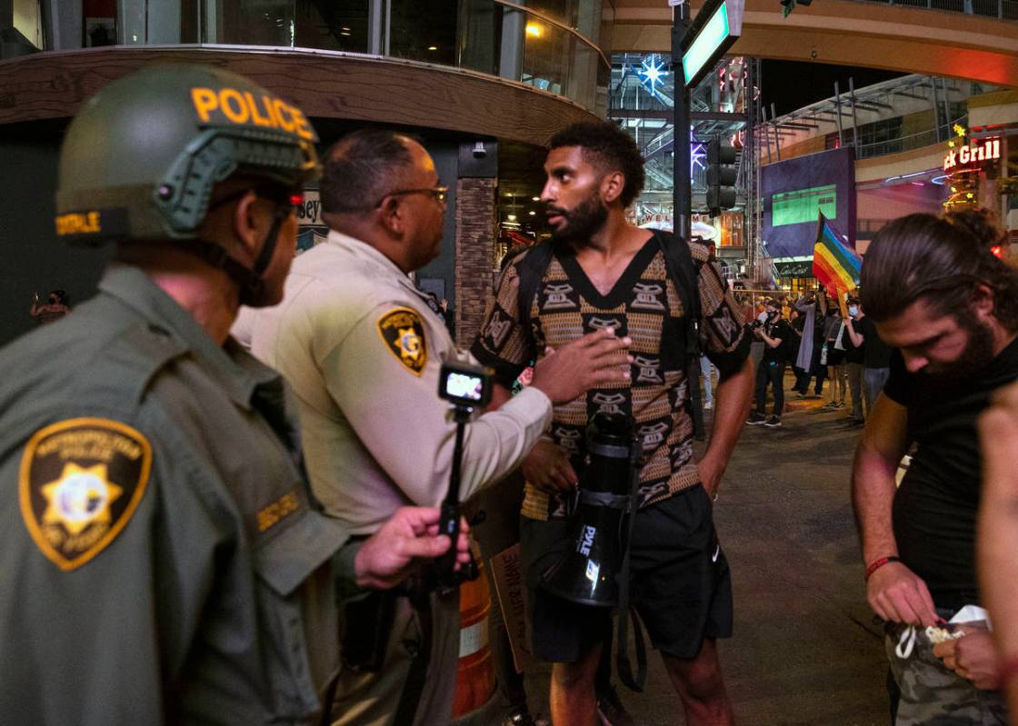 A protest organizer, calling for justice in the shooting death of Breonna Taylor, negotiates wi ...