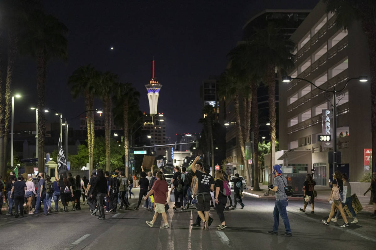 Demonstrators cross Las Vegas Blvd., while protesting in honor of Breonna Taylor, in downtown L ...