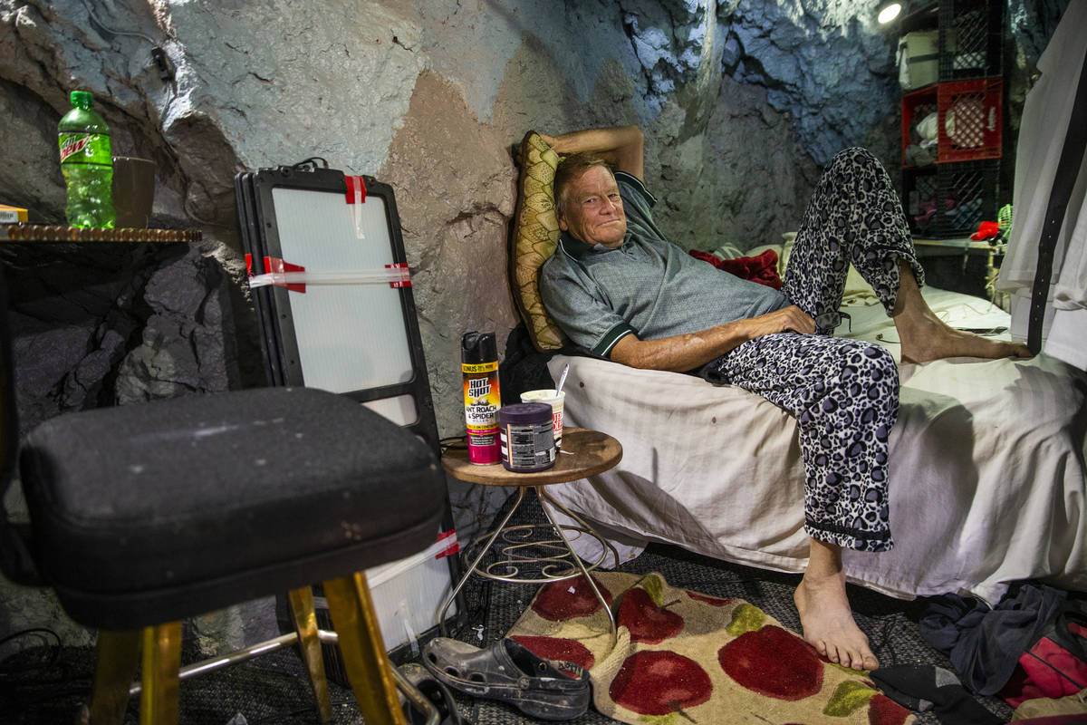 Richard Roman relaxes on his bed while living in a former mine in the hillside above the River ...