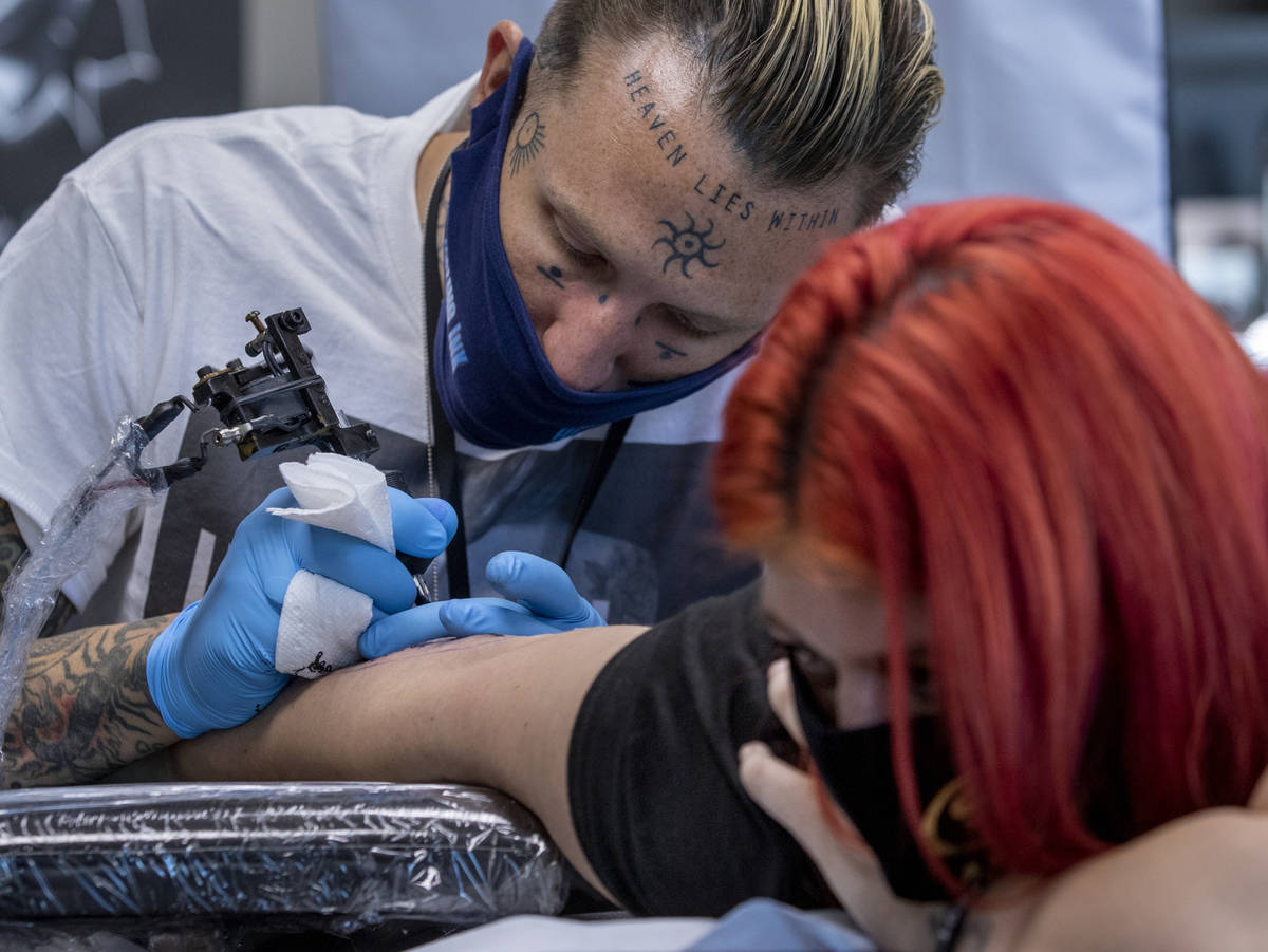 Tattoo artist Dylan Rossage works on Ashley Williams as Route 91 shooting survivors and first r ...