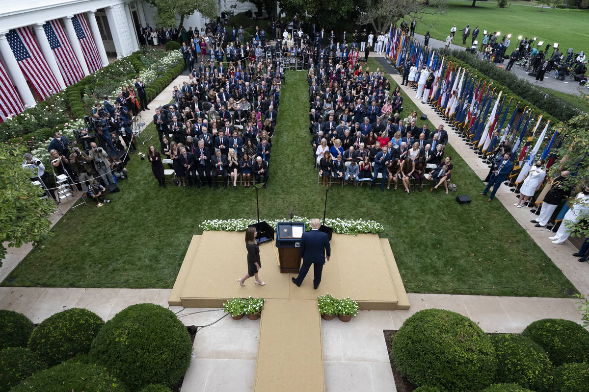 Judge Amy Coney Barrett walks to the microphone after President Donald Trump, right, announced ...