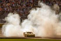 Joey Logano (22) celebrates with a burn out at the finish line following his win in the Pennzoi ...