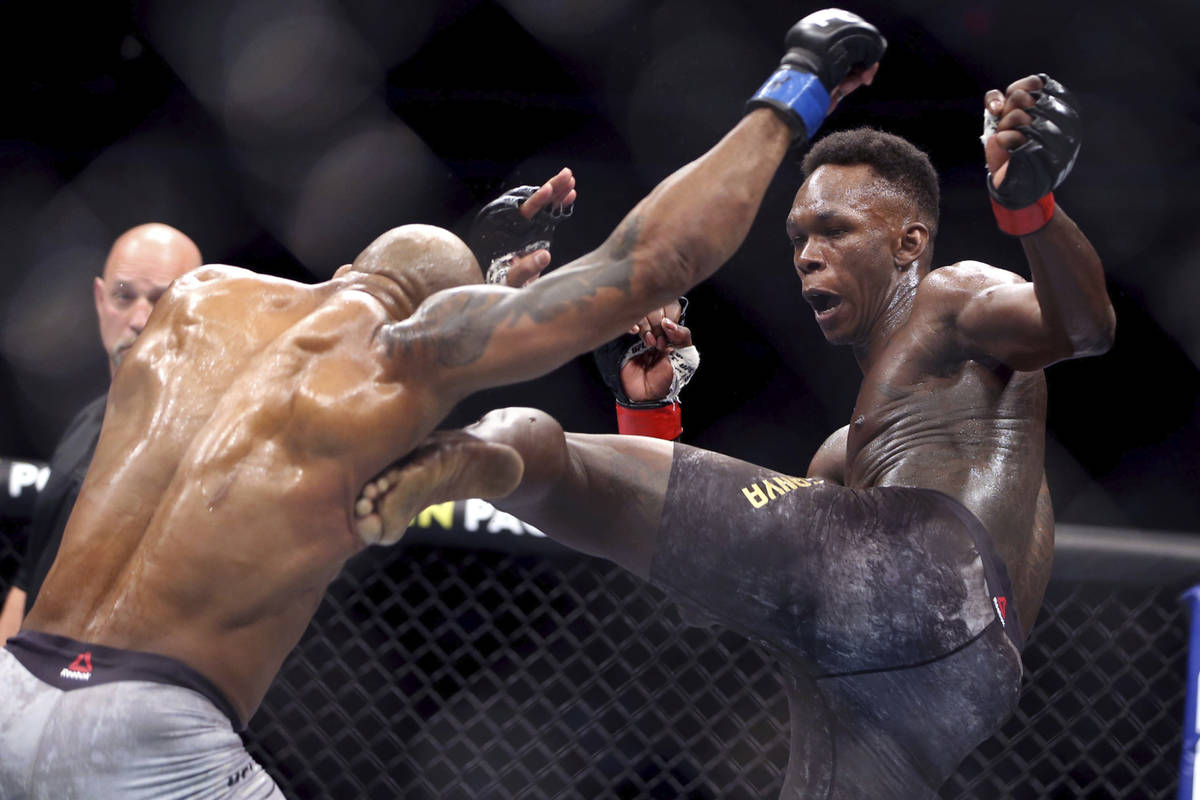 In this March 7, 2020, file photo, UFC middleweight champion Israel Adesanya, right, of Nigeria ...