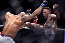 In this March 7, 2020, file photo, UFC middleweight champion Israel Adesanya, right, of Nigeria ...