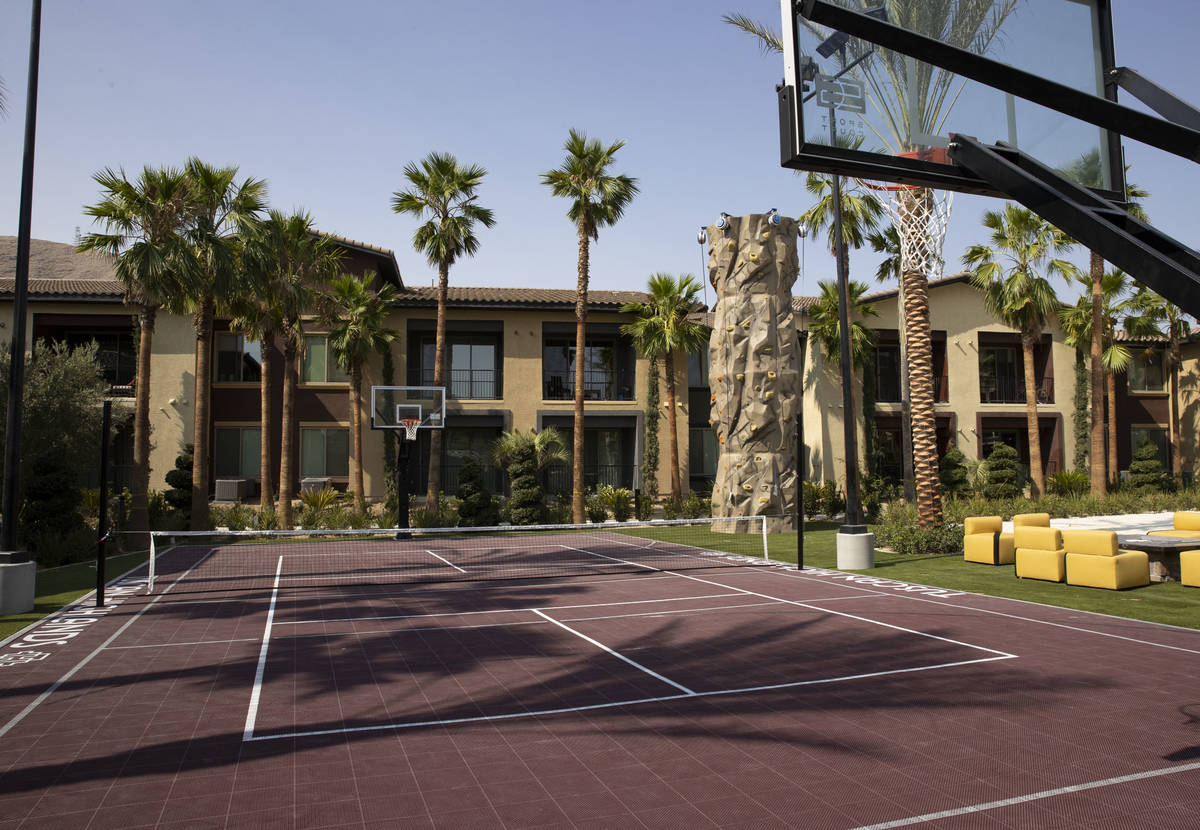 A tennis court and basketball court are seen at the Tuscan Highlands apartment complex under co ...