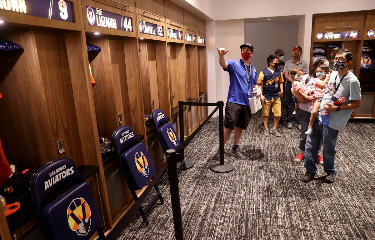Nathan Erbach, left, Las Vegas Aviators account executive, shows the home home locker room duri ...