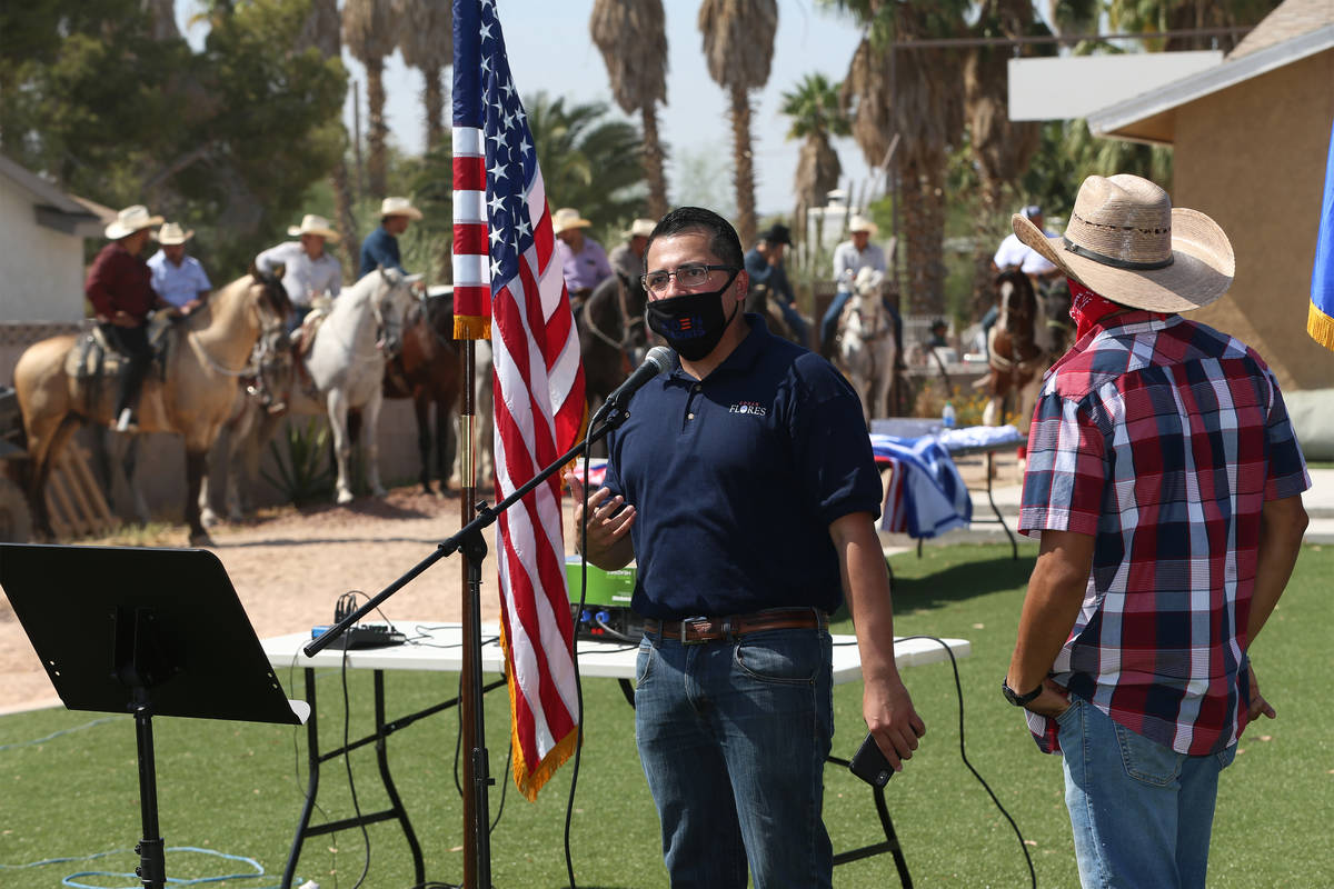 Assemblyman Edgar Flores speaks to supporters at his neighbor's home before taking to the stree ...