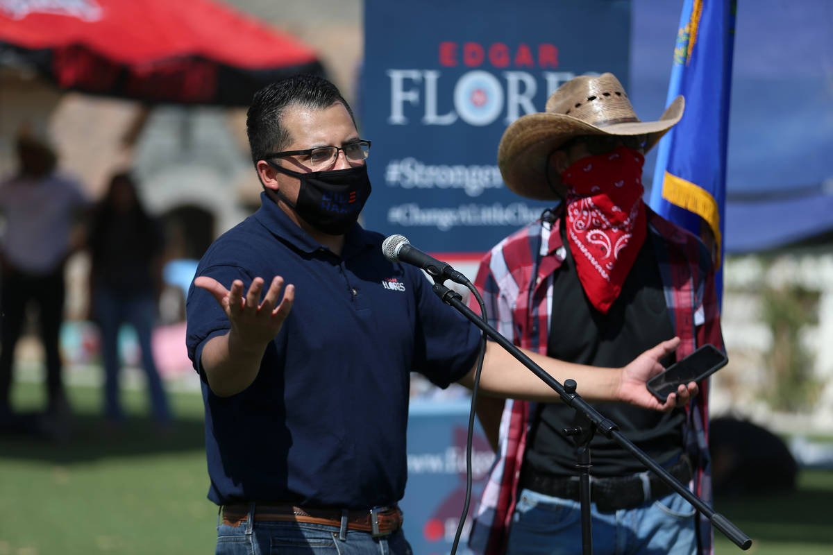 Assemblyman Edgar Flores speaks to supporters at his neighbor's home before taking to the stree ...