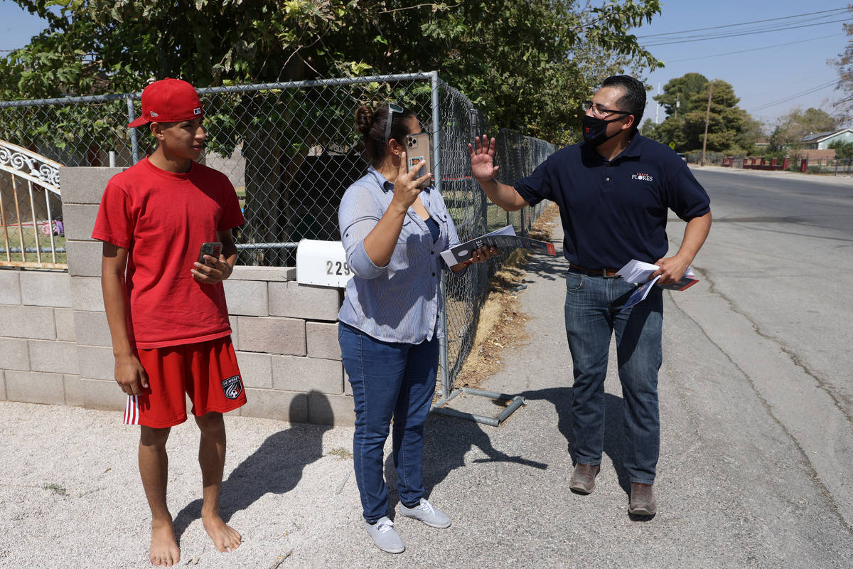 Assemblyman Edgar Flores, right, meets Maria Salazar and her son Allen Guerrero while canvassin ...