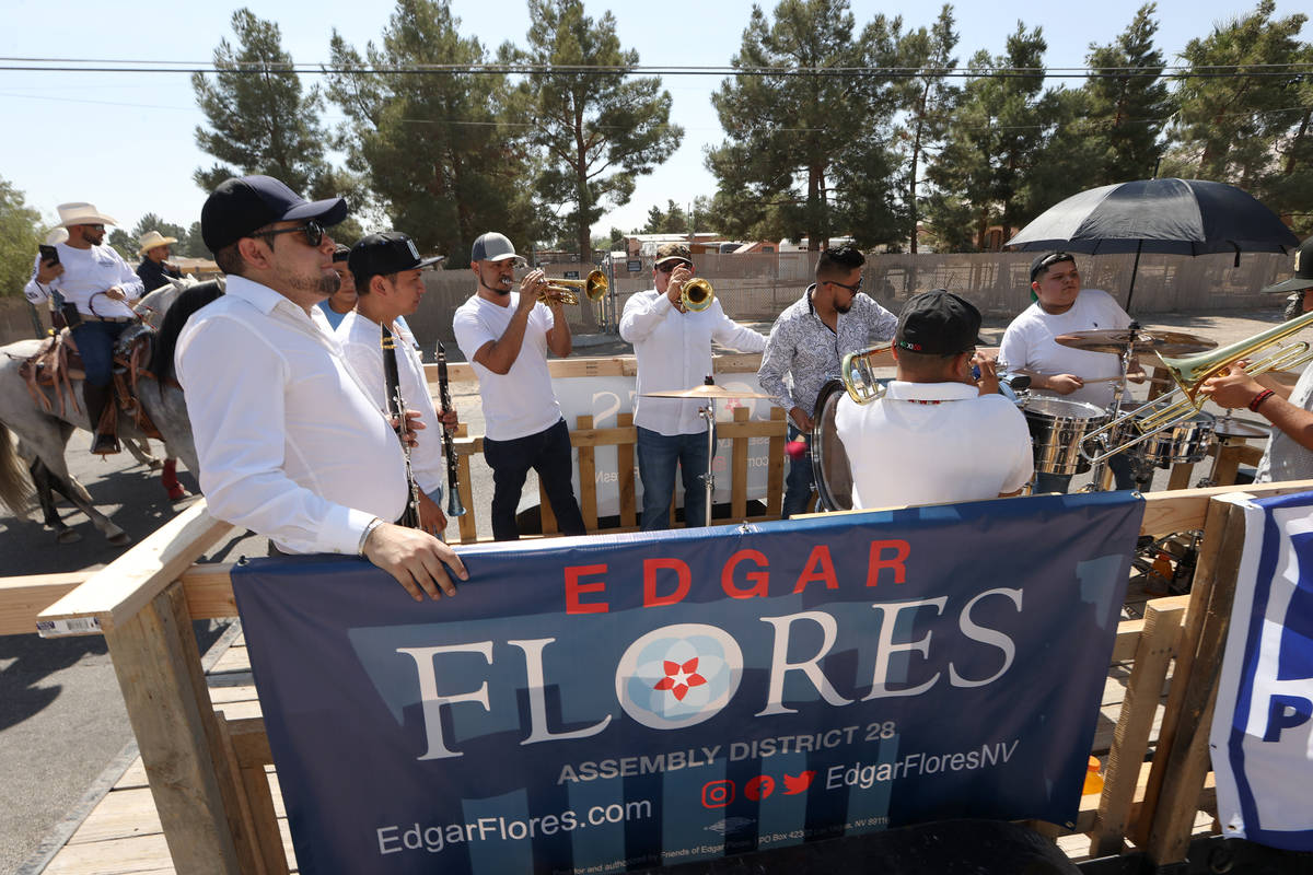 A music band performs while moving on top of an utility trailer during a canvassing event for ...