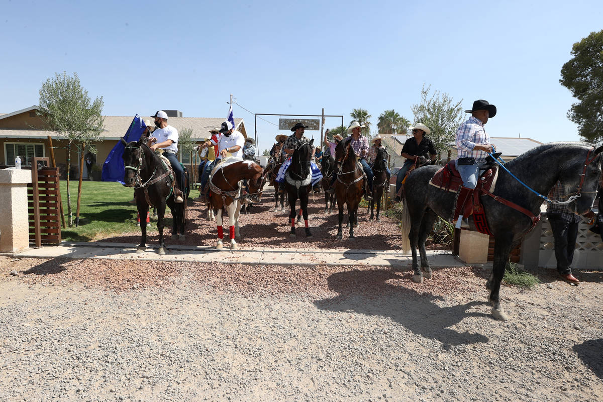 Horseback riders participate in the re-election campaign event for Assemblyman Edgar Flores in ...