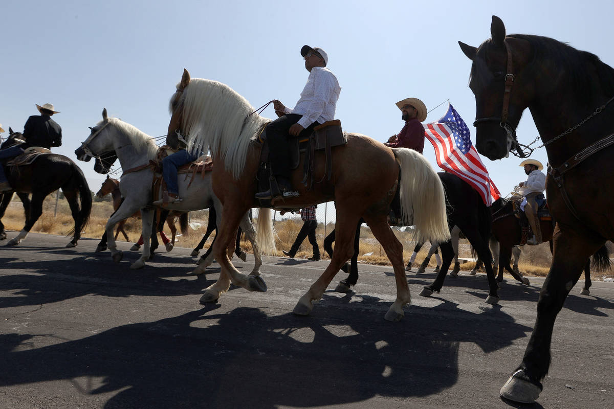 Horseback riders participate in the re-election campaign event for Assemblyman Edgar Flores in ...