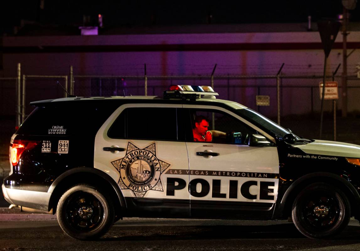 A Las Vegas police officer keeps an eye on people marching during a protest against U.S. Immigr ...