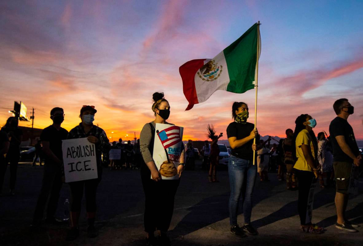 People gather before marching downtown to protest against U.S. Immigration and Customs Enforcem ...
