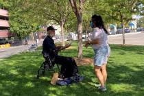 A volunteer with the Reno Burrito Project handing out free burritos at City Plaza in downtown R ...