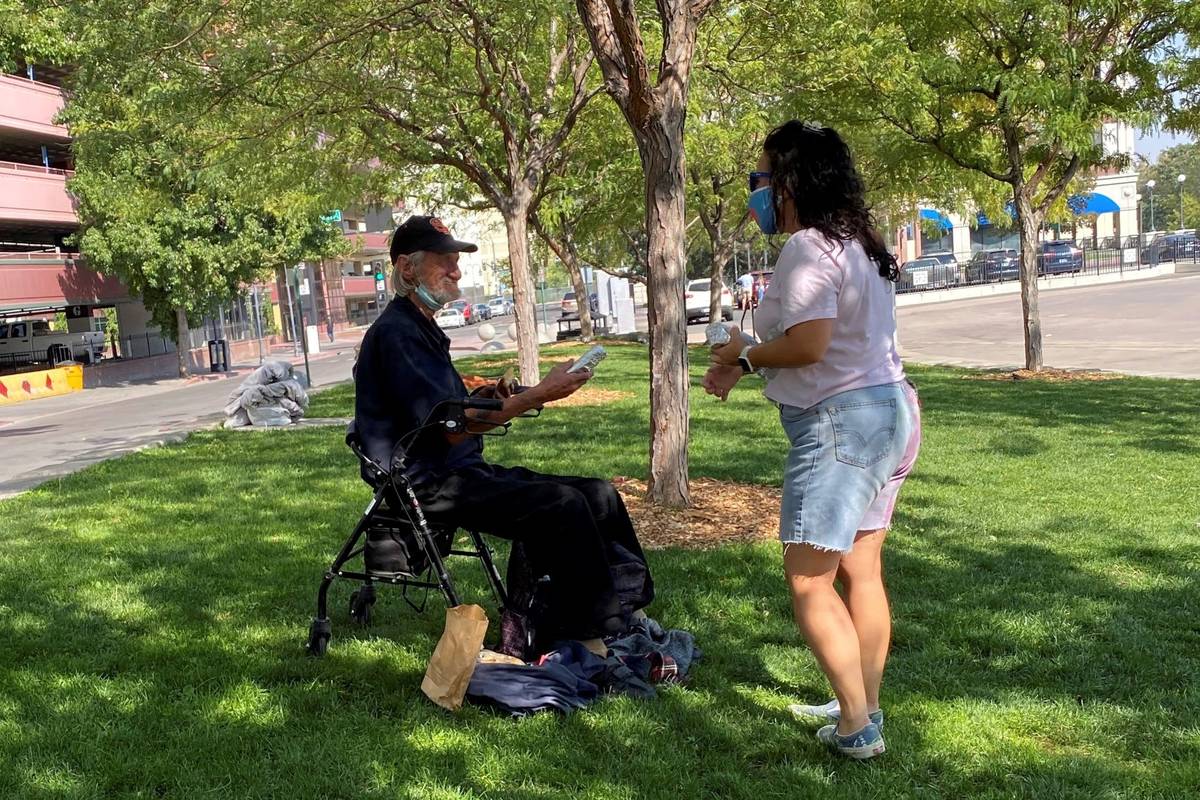 A volunteer with the Reno Burrito Project handing out free burritos at City Plaza in downtown R ...