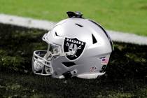 A Las Vegas Raiders helmet sits on the field prior to an NFL football game against the New Orle ...