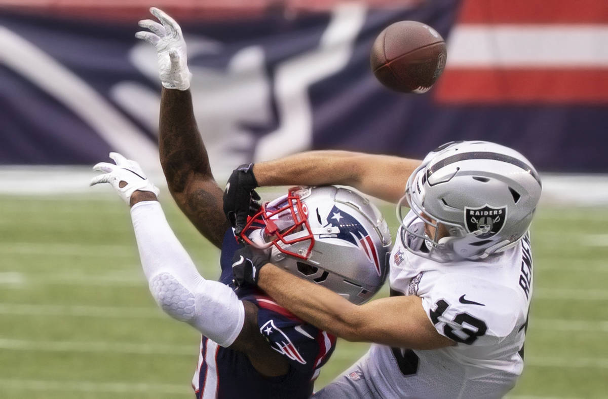 Las Vegas Raiders wide receiver Hunter Renfrow (13) fights for a reception with New England Pat ...