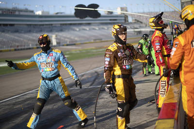 The pit crew for Kyle Busch (18) sends off his car during a NASCAR Cup Series auto race on ...