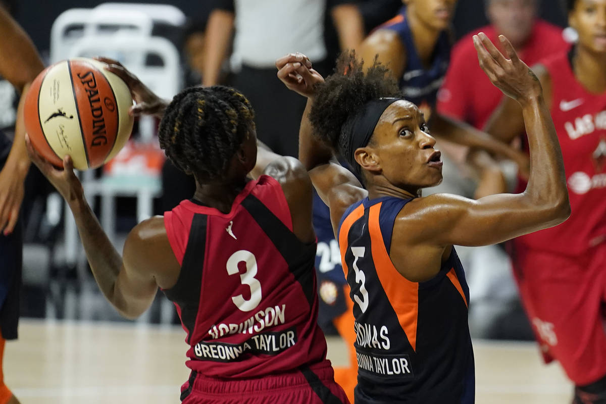 Connecticut Sun guard Jasmine Thomas (5) fouls Las Vegas Aces guard Danielle Robinson (3) durin ...