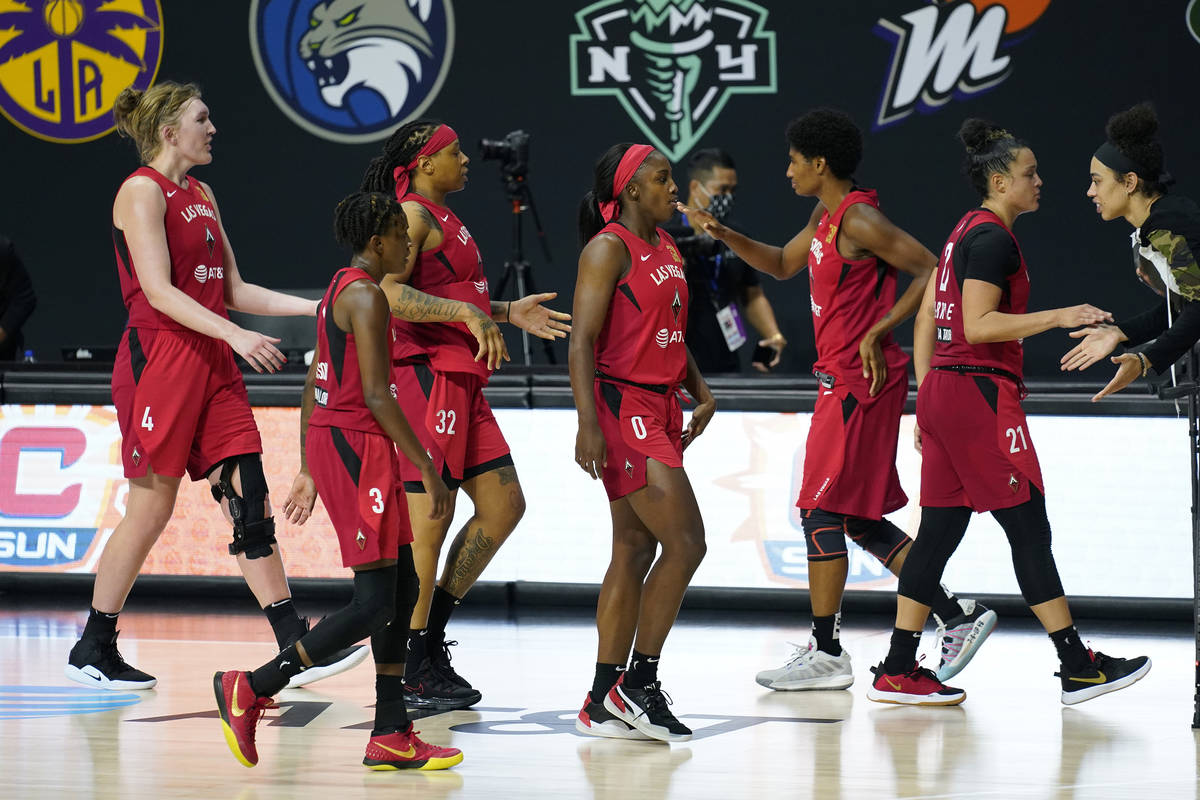 The Las Vegas Aces celebrate their win over the Connecticut Sun during Game 4 of a WNBA basketb ...