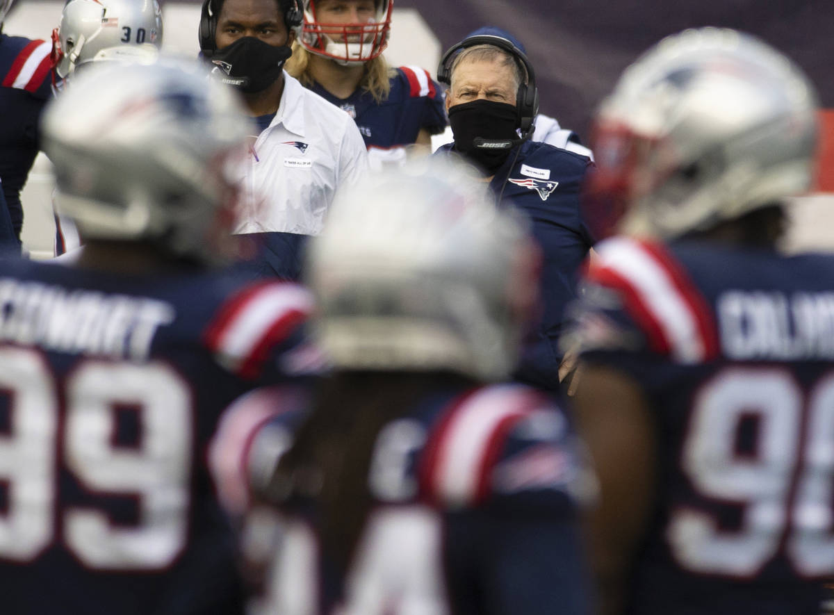 New England Patriots head coach Bill Belichick watches his defense during a time out in the thi ...
