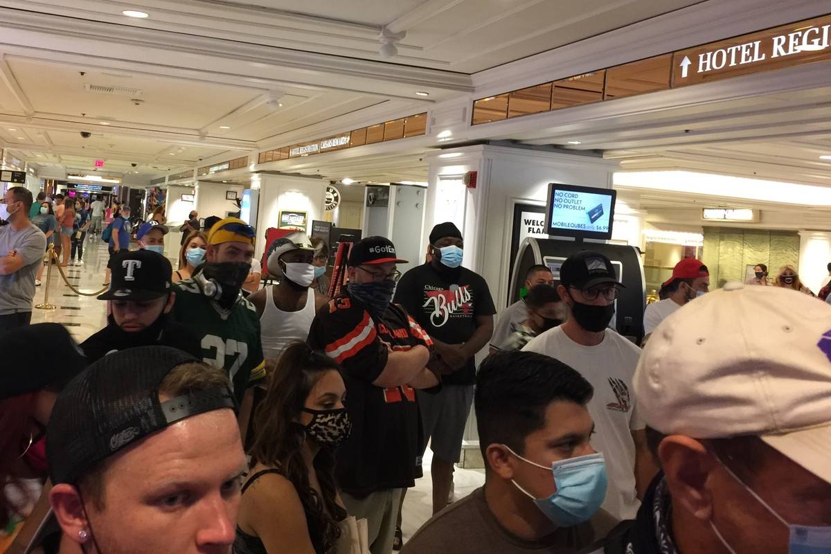 Visitors wait in a line during a lockdown at the Flamingo on Monday, Sept. 28, 2020. (Andrew Sc ...