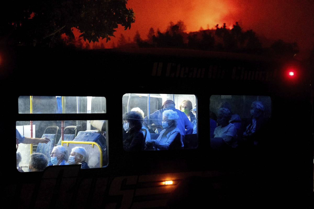 Residents of the Oakmont Gardens senior home evacuate on a bus as the Shady Fire approaches in ...