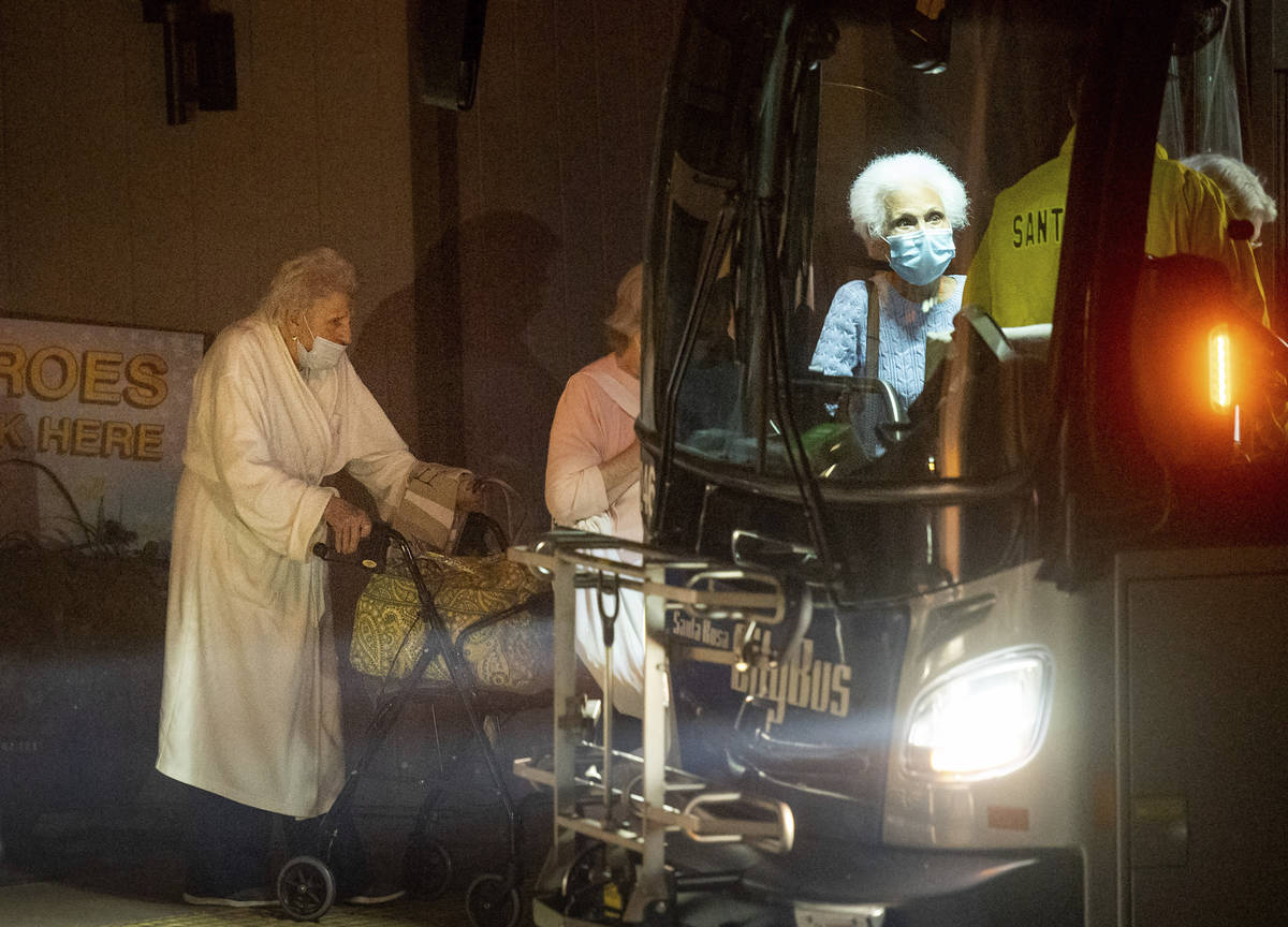 Residents of the Oakmont Gardens senior home evacuate by bus as the Shady Fire approaches Santa ...