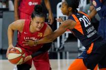 Connecticut Sun guard Briann January (20) fouls Las Vegas Aces guard Kayla McBride (21) during ...