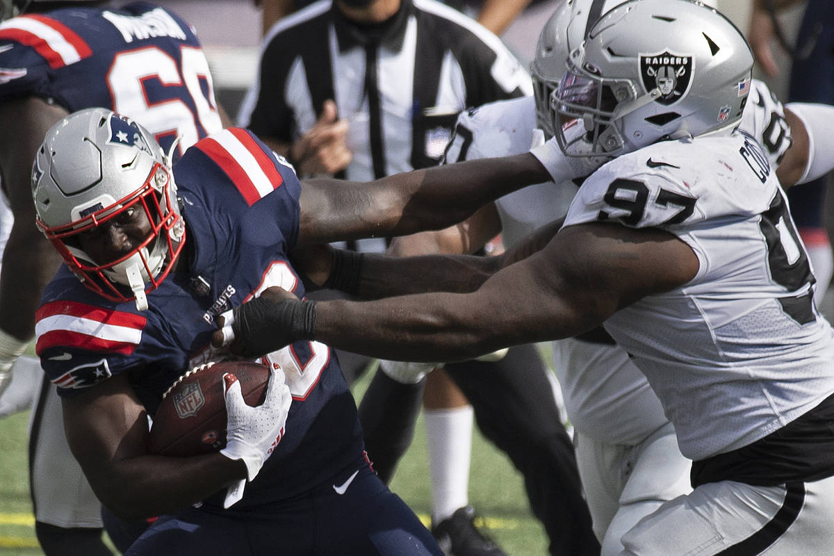 New England Patriots running back Sony Michel (26) tries to break free from  Las Vegas Raiders d …