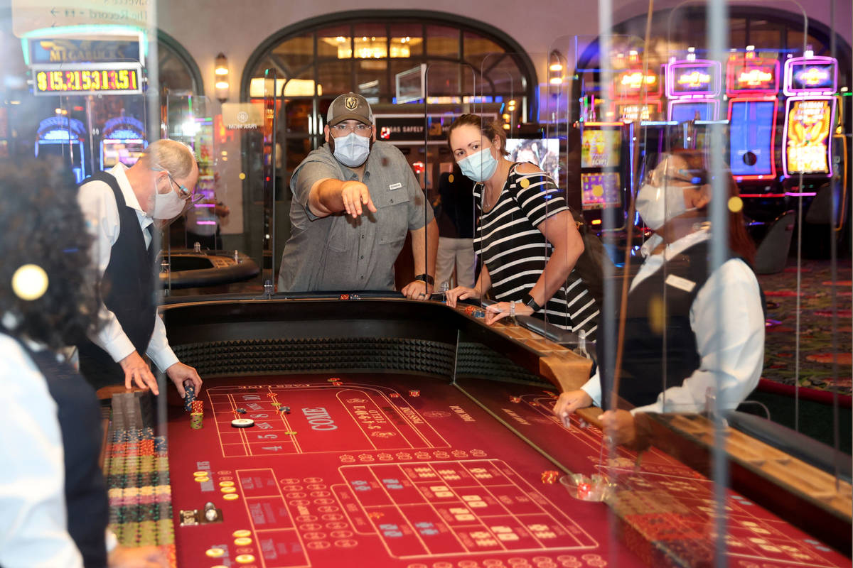 Matt and Angela Tooley of Temple, Texas play craps as Park MGM reopens after the coronavirus sh ...