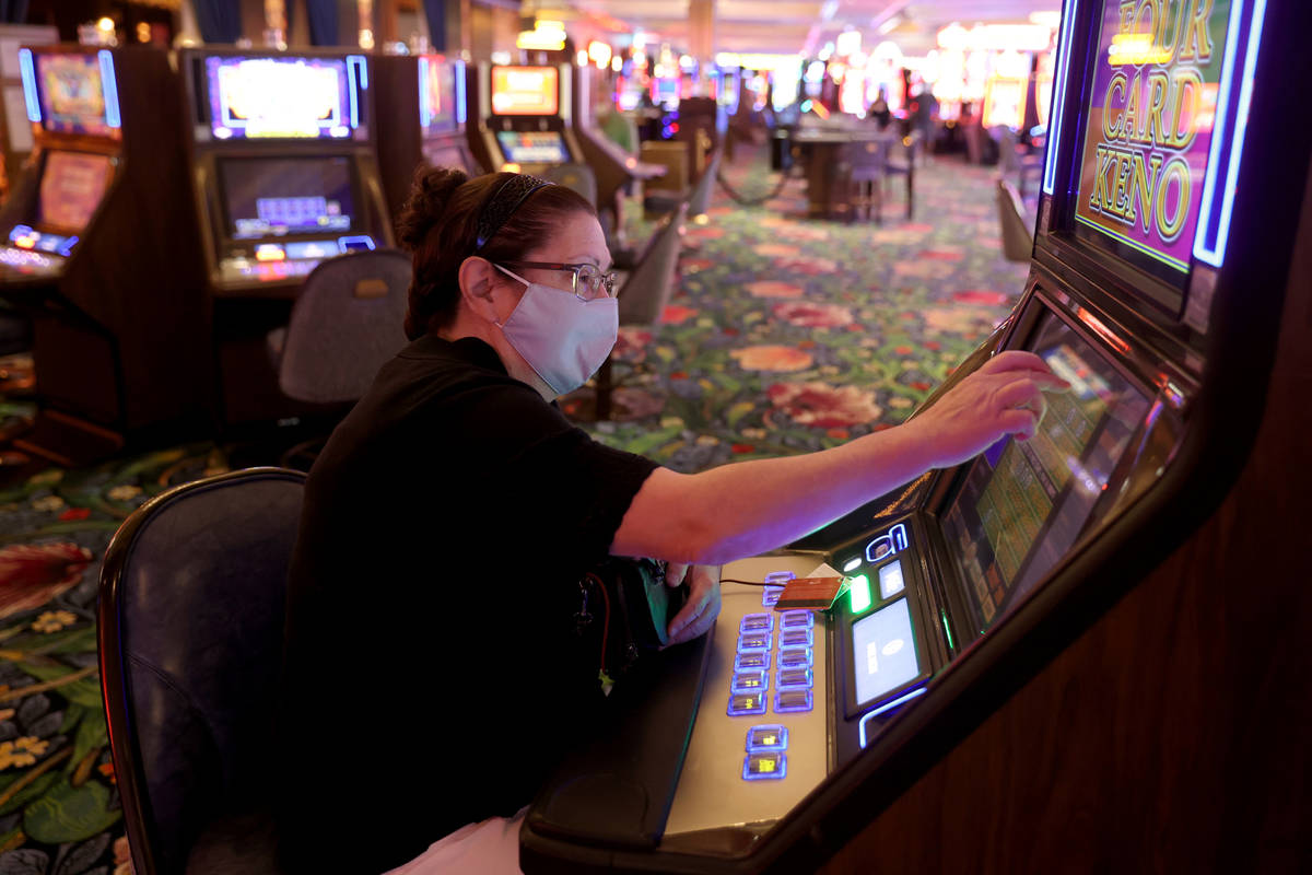 Sue Panici of Muskegon, Mich. plays a machine as Park MGM reopens after the coronavirus shutdow ...