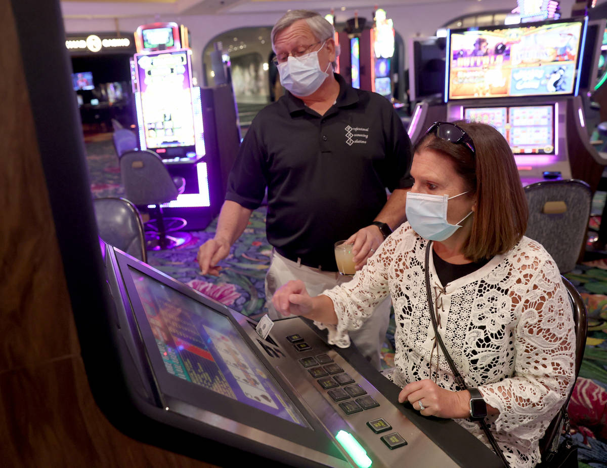 Sharon and Don Jones of Muskegon, Mich. play a machine as Park MGM reopens after the coronaviru ...