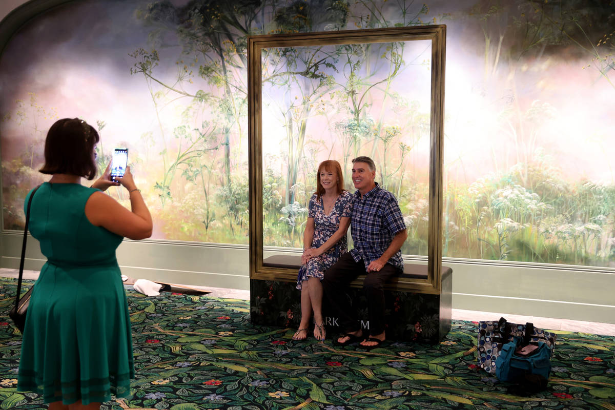 Lucy Angelo of Las Vegas takes a photo of Tim and Alisa Gaw of Phoenix as Park MGM reopens afte ...