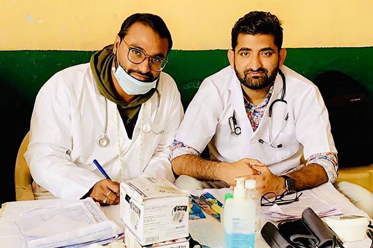 In this October 2019 photo provided by Bharat Sangwan, Joginder Chaudhary, left, and his friend ...