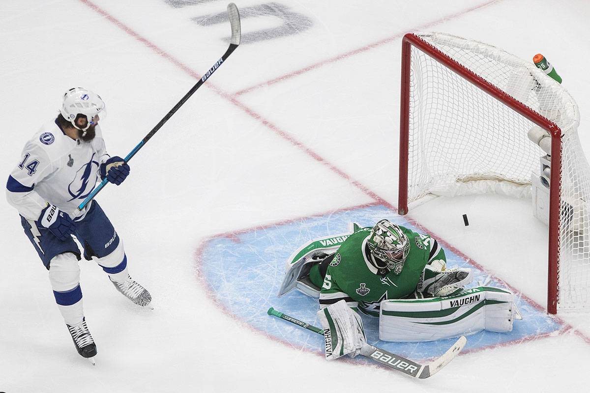 Tampa Bay Lightning's Pat Maroon (14) watches the puck go in past Dallas Stars goalie Anton Khu ...