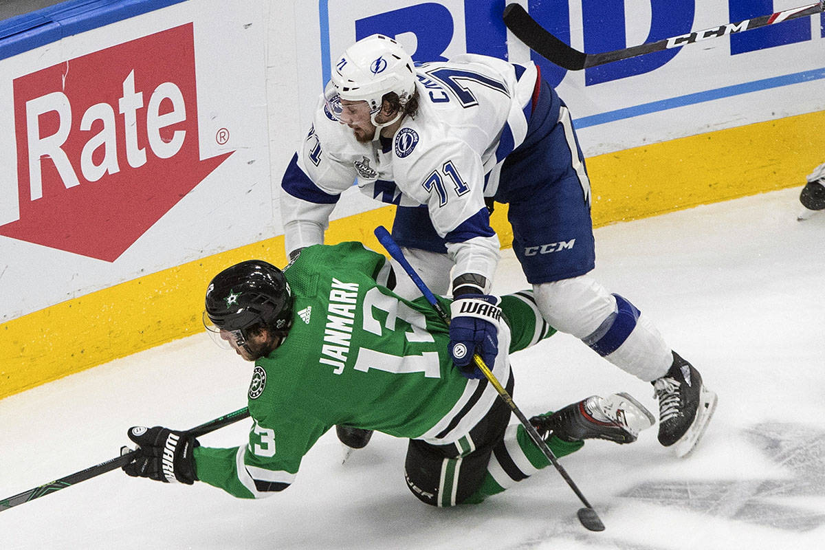 Tampa Bay Lightning's Anthony Cirelli (71) checks Dallas Stars' Mattias Janmark (13) during the ...