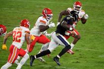 Baltimore Ravens quarterback Lamar Jackson (8) scrambles as he is pursued by Kansas City Chiefs ...