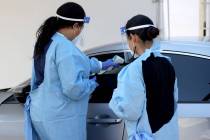 UNLV Medicine certified medical assistants test curbside for COVID-19 at the school in Las Vega ...