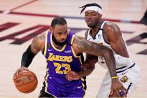 Los Angeles Lakers' LeBron James (23) drives against Denver Nuggets' Jerami Grant during the se ...