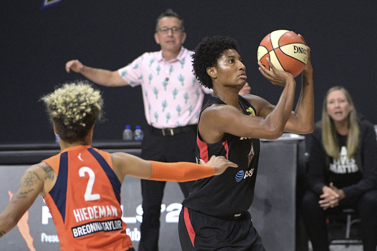 Las Vegas Aces forward Angel McCoughtry, right, sets up for a shot in front of Connecticut Sun ...