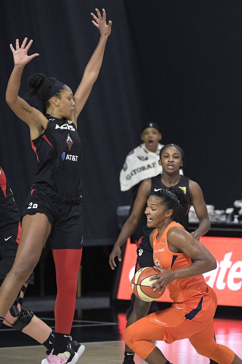 Connecticut Sun forward Alyssa Thomas drives to the basket in front of Las Vegas Aces center A' ...