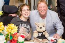 Las Vegas Raiders owner Mark Davis is shown with Opportunity Village client Sarah Brown during ...
