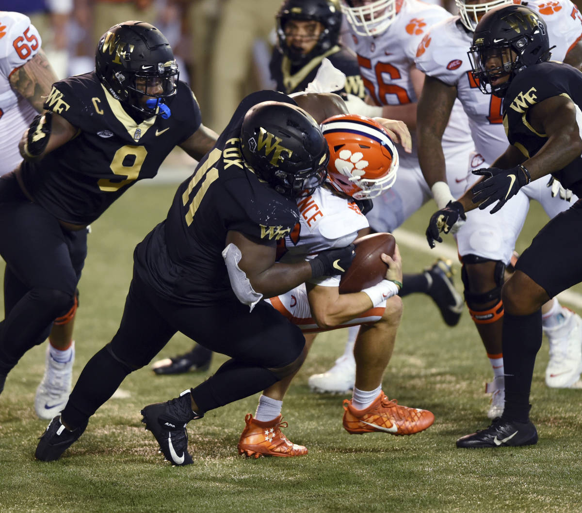 Wake Forest defensive lineman Miles Fox sacks Clemson quarterback Trevor Lawrence in the first ...